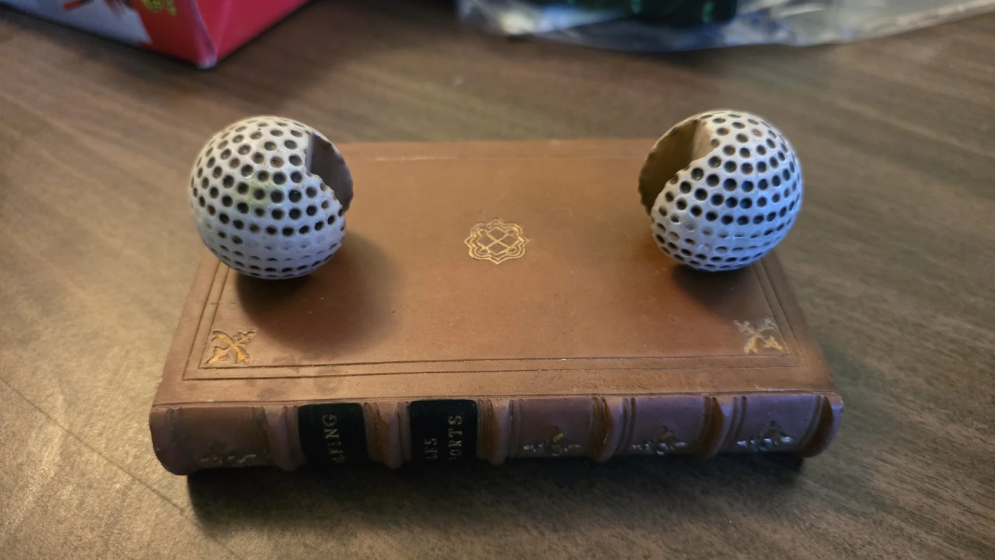 Book shaped box with two decorative golf ball halves