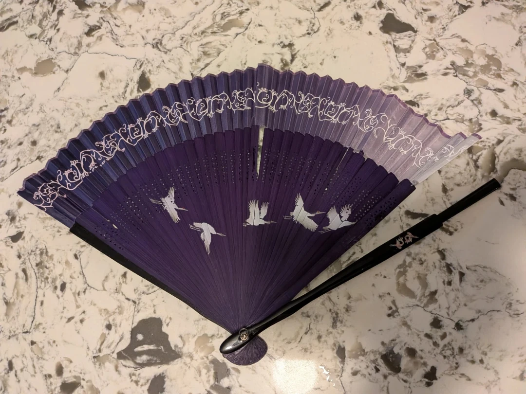**Broken Purple Folding Fan with Crane Design