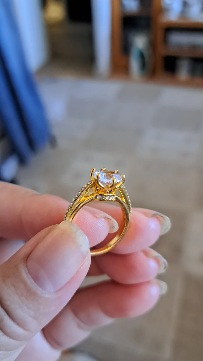 Gold-tone engagement ring with clear stone