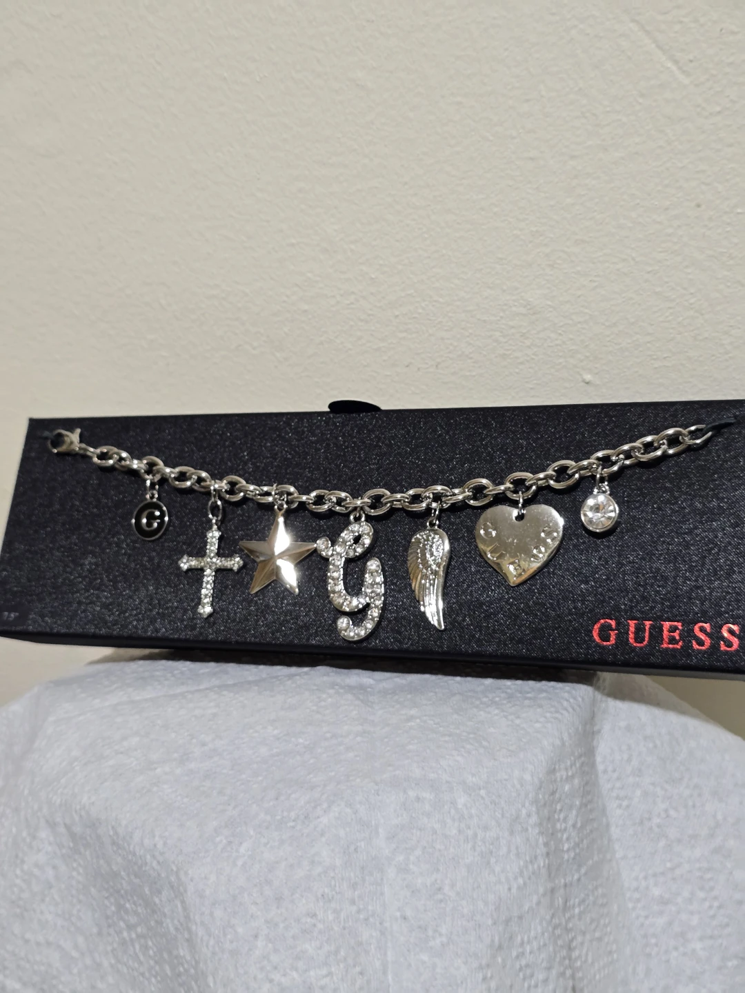 Guess Charm Bracelet with Cross, Star, G, Wing, and Heart Charms