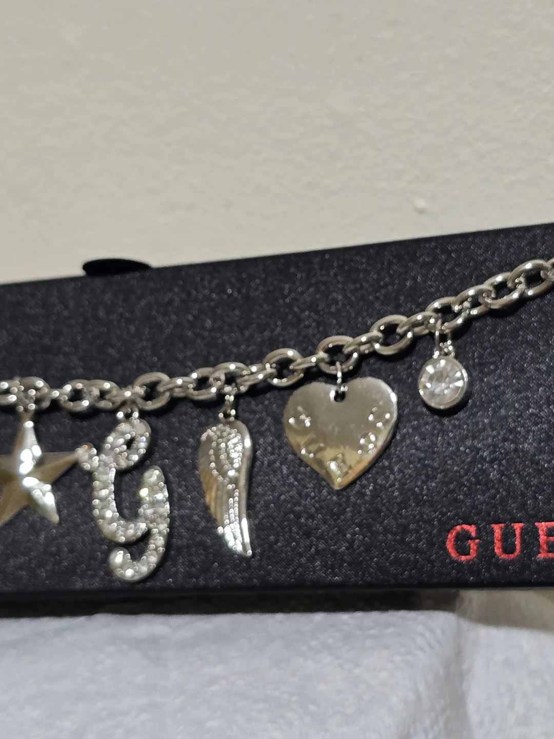 Guess Charm Bracelet with Cross, Star, G, Wing, and Heart Charms - photo 5