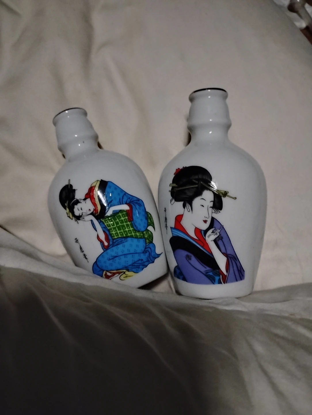 Two Ceramic Sake Bottles with Geisha Art