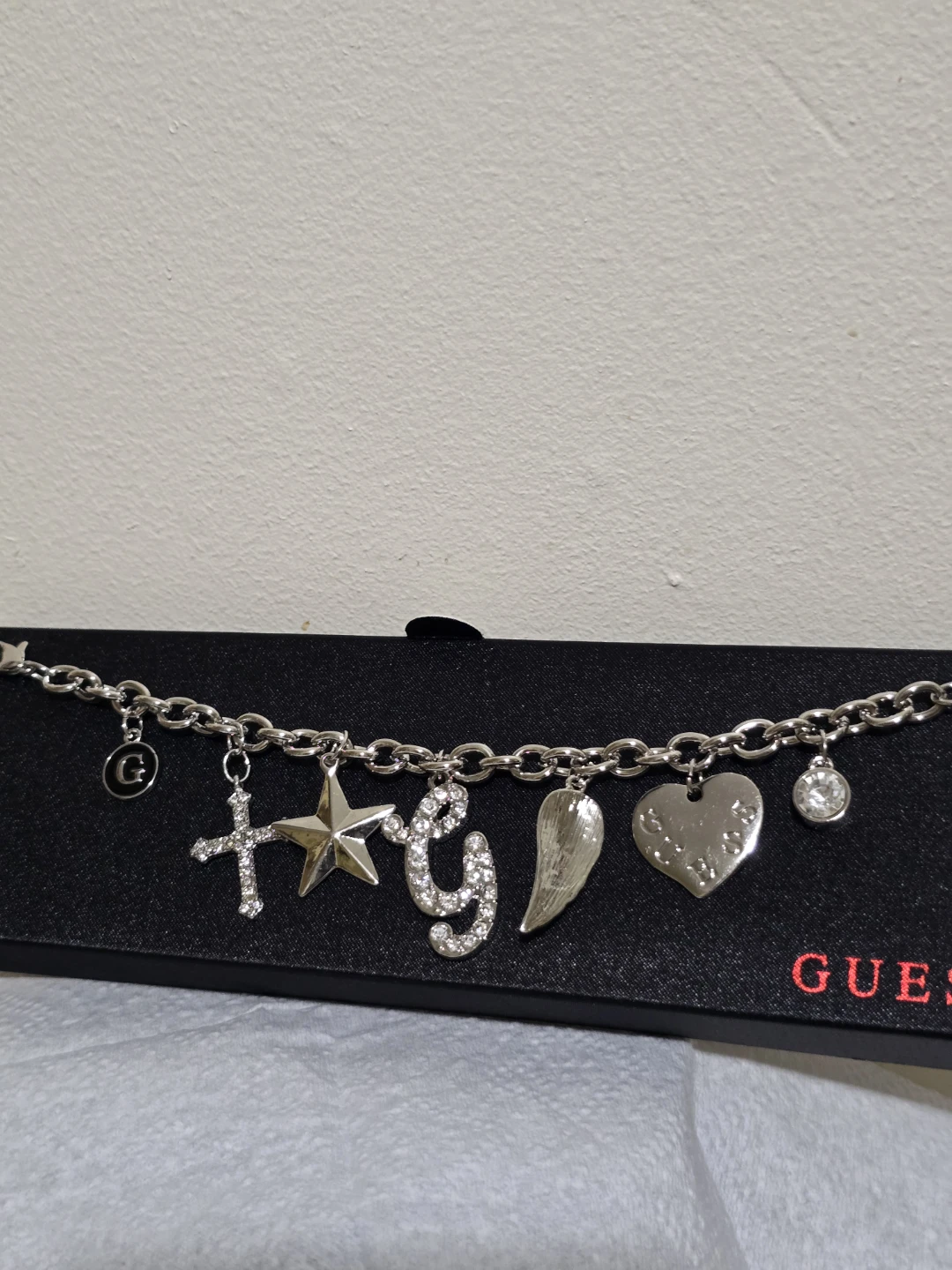 Guess Charm Bracelet with Cross, Star, G, Wing, and Heart Charms - photo 3