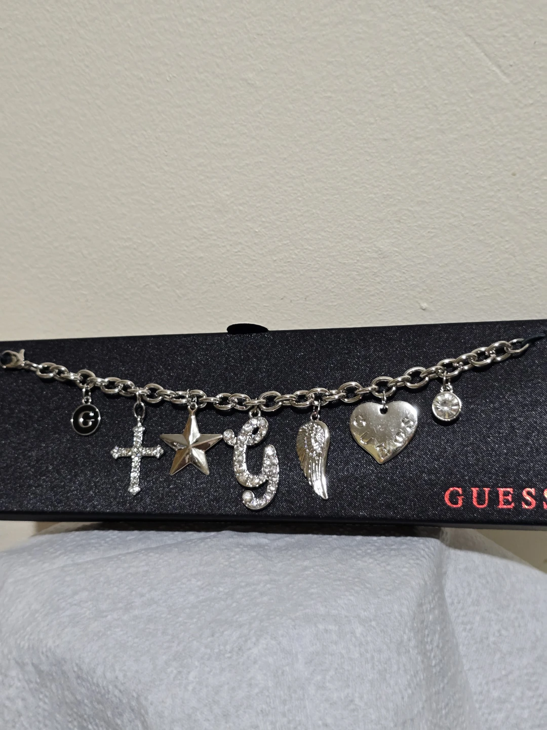 Guess Charm Bracelet with Cross, Star, G, Wing, and Heart Charms - photo 4