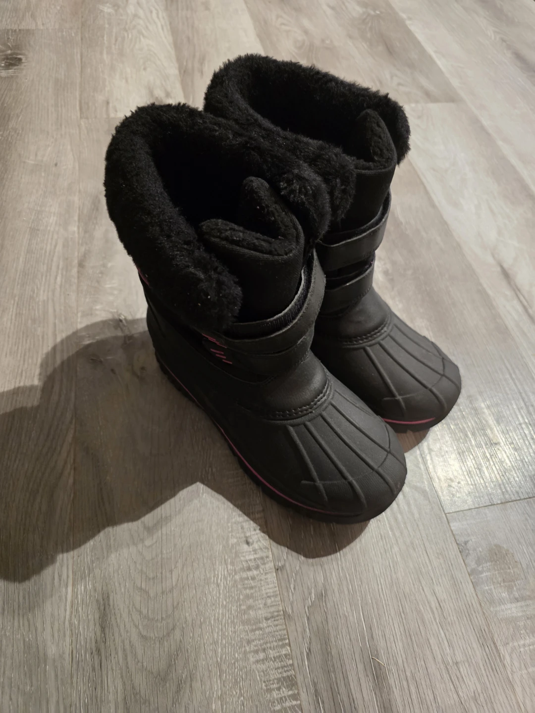 Black winter boots with pink accents