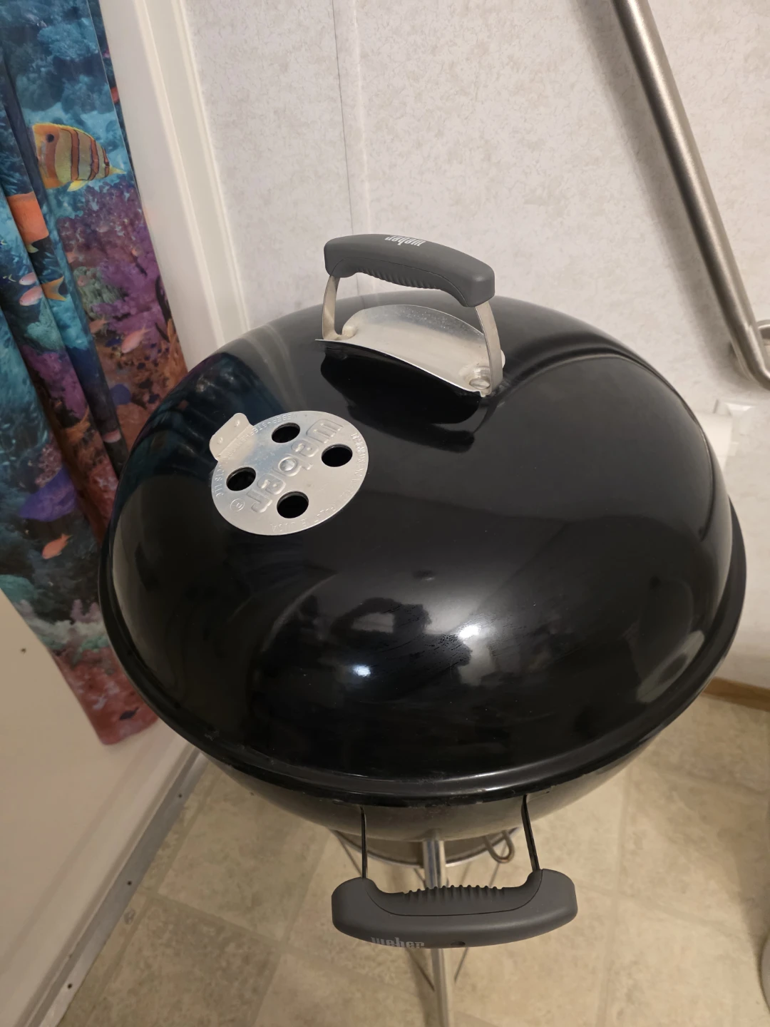 Weber round charcoal grill on wheels.