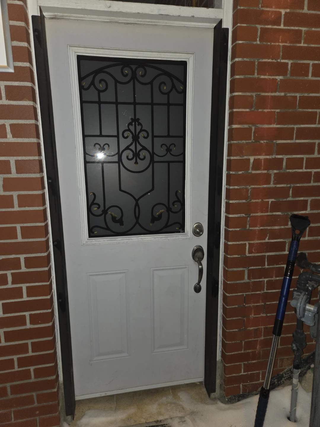 White exterior door with decorative glass panel