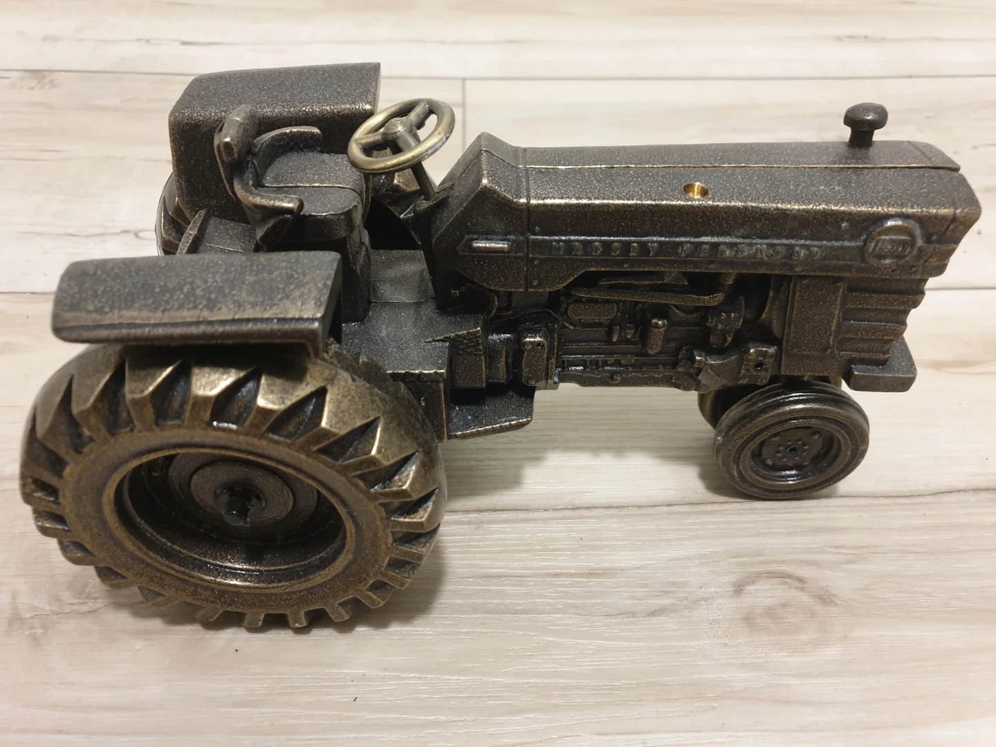 Collectible brass replica of a Massey Ferguson 1100 tractor