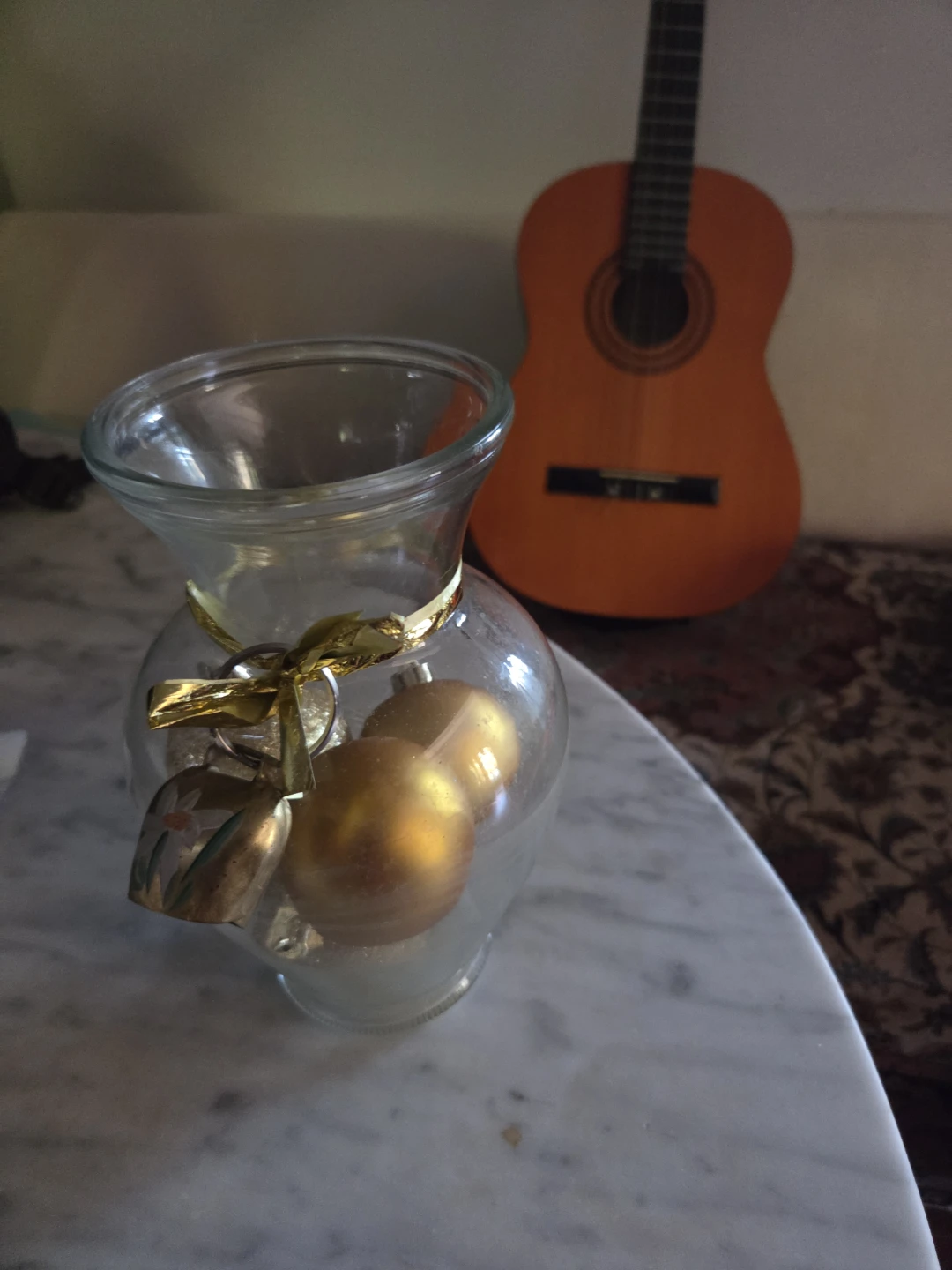 Glass vase with gold Christmas ornaments