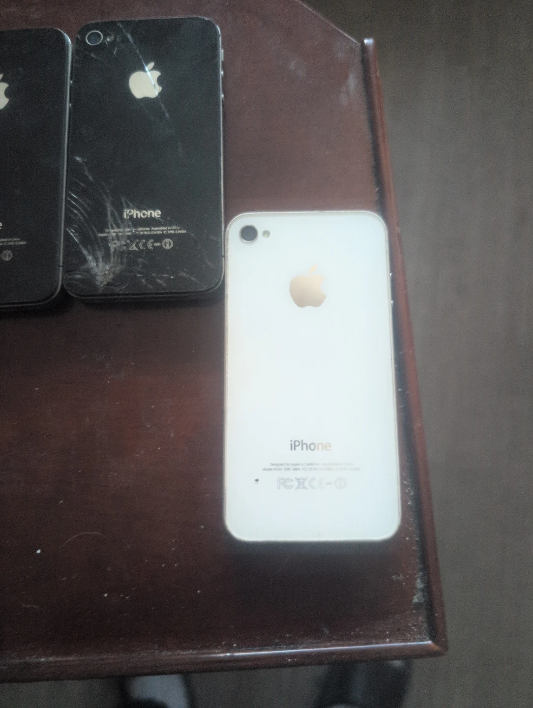 Assorted iPhones (Red, Black, White)