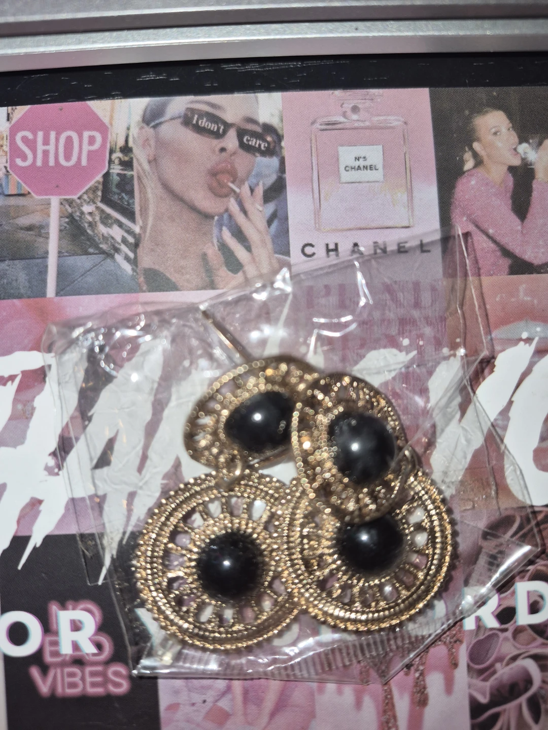 Gold tone filigree drop earrings with black stones