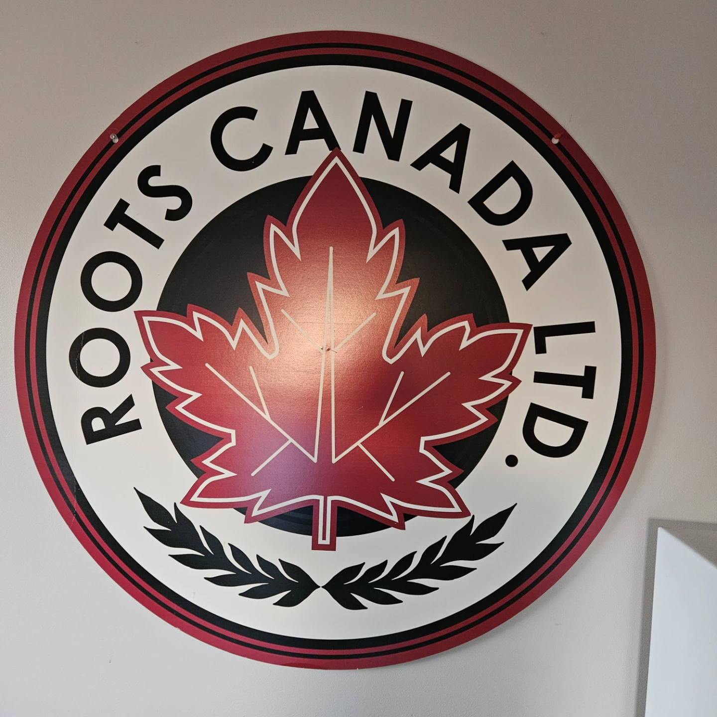 Roots Canada Ltd. Round Sign