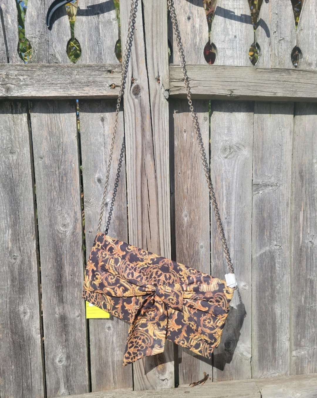 Clutch purse with ornate gold and black pattern