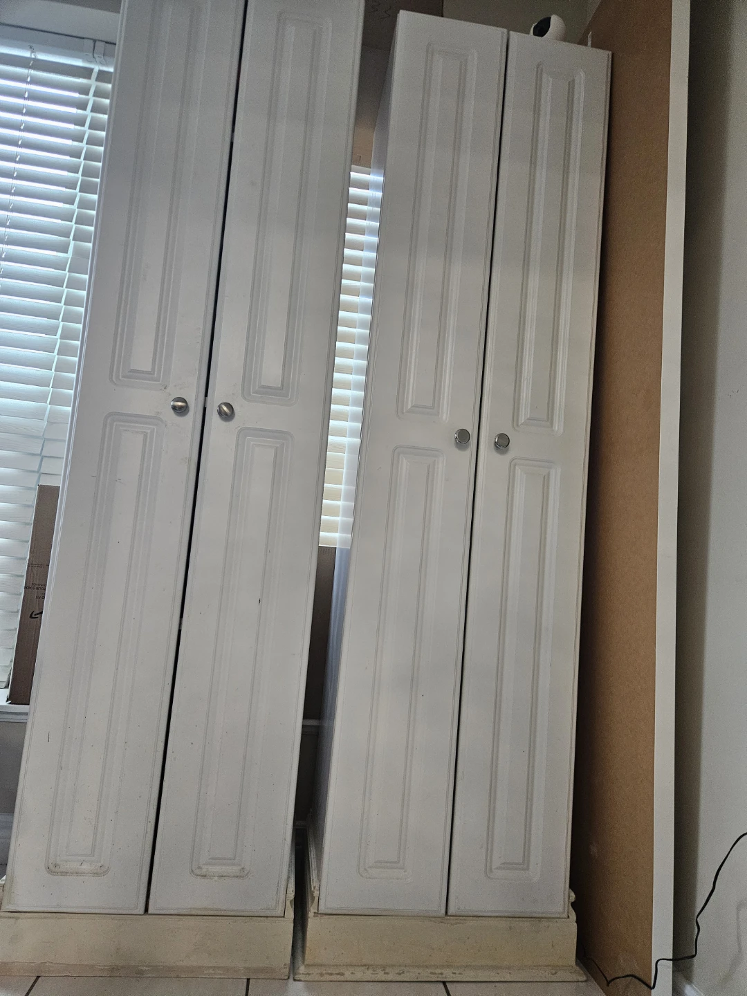 Two White Tall Cabinets with Doors