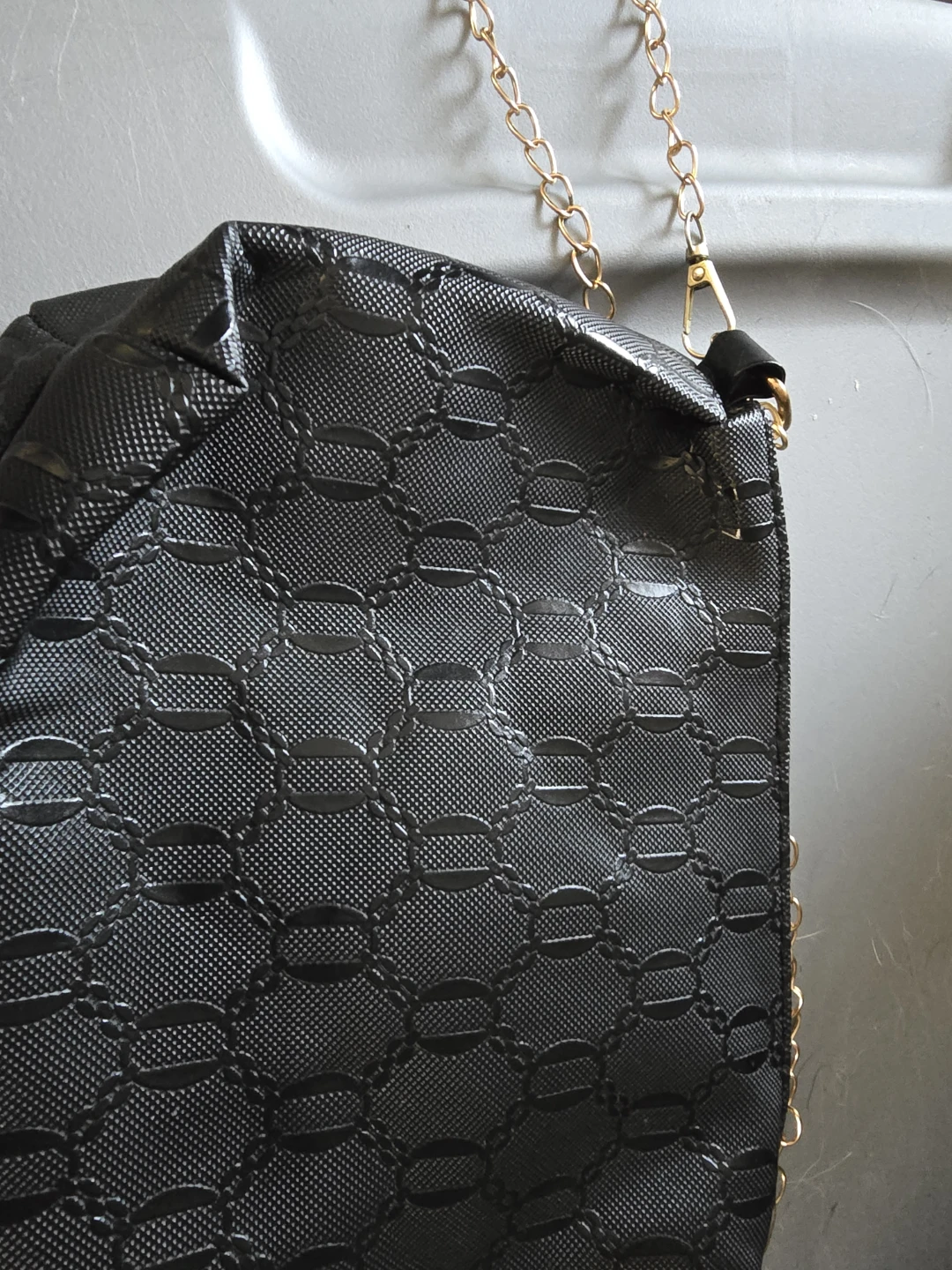 Black textured clutch with gold chain
