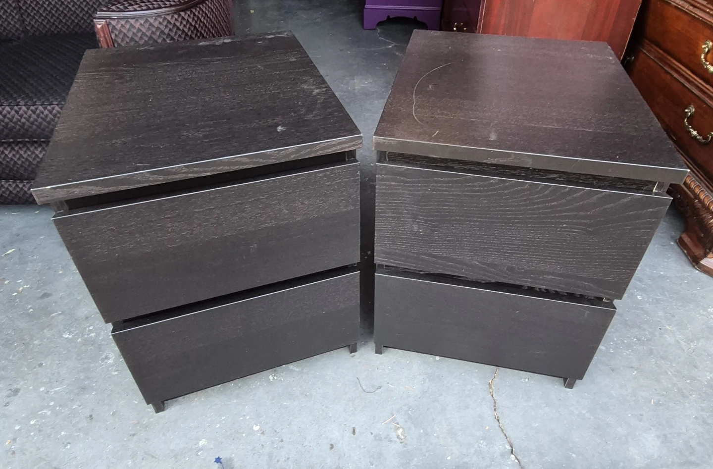 Two dark wood nightstands with drawers