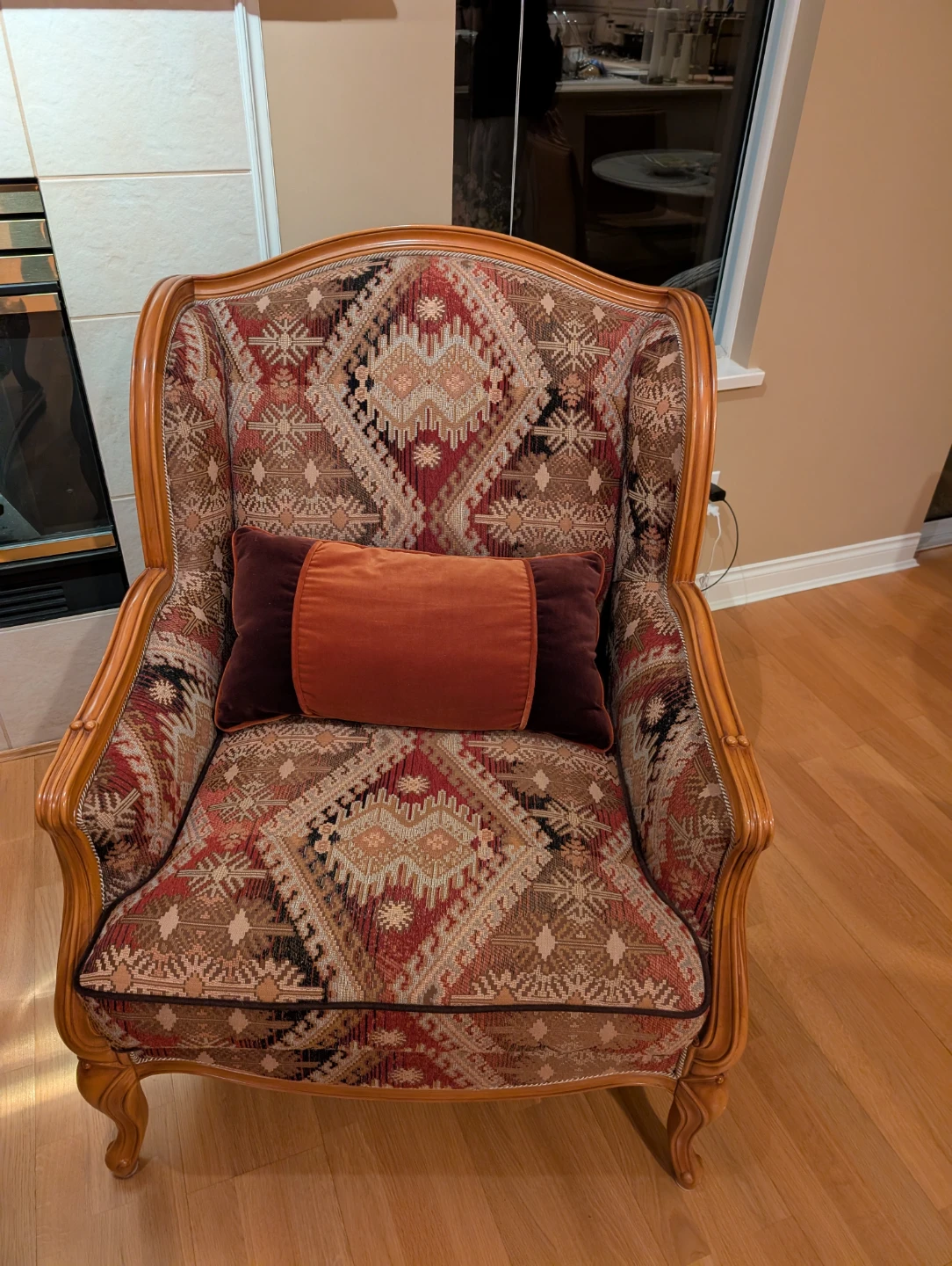 Armchair with ornate fabric and wooden frame