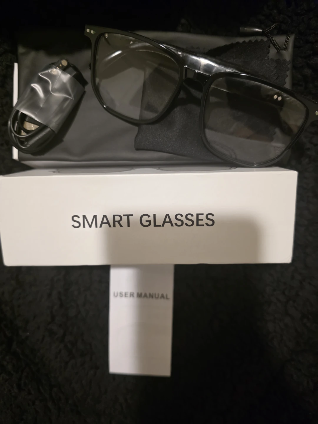 Black Smart Glasses with Charging Cable and User Manual