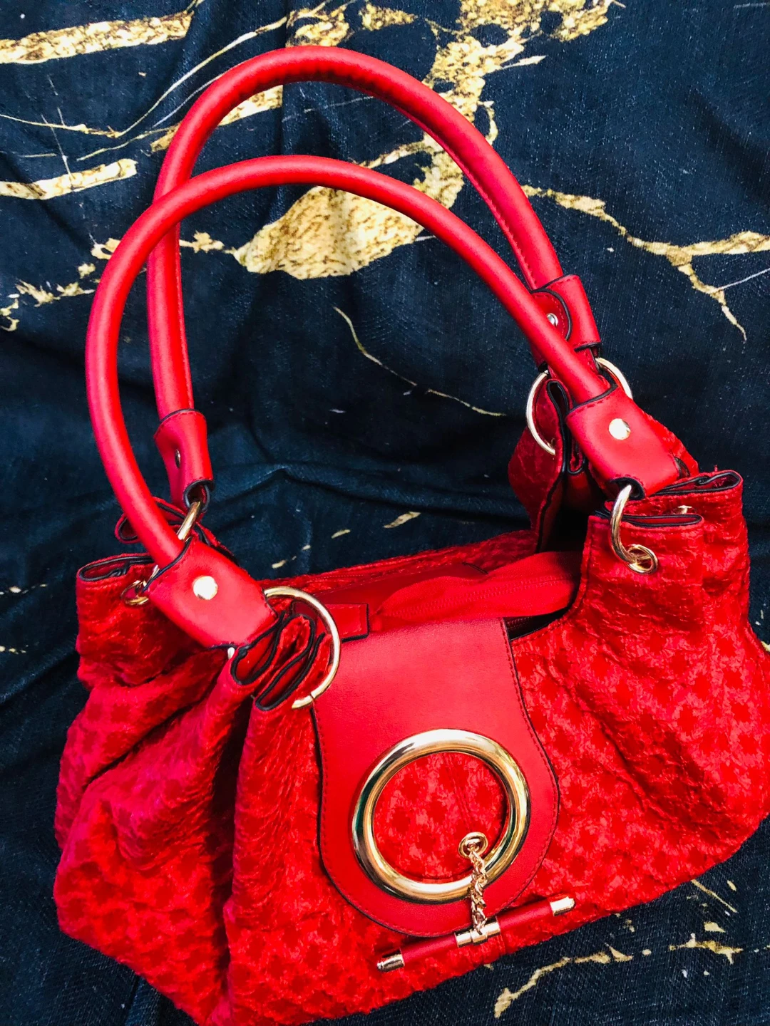 Red textured bag with gold hardware