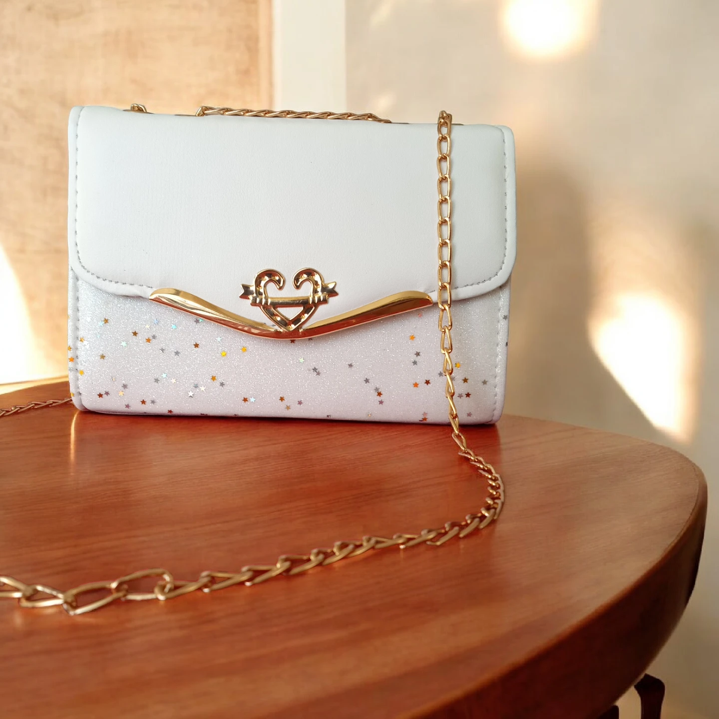 White sparkly cross body purse with gold chain