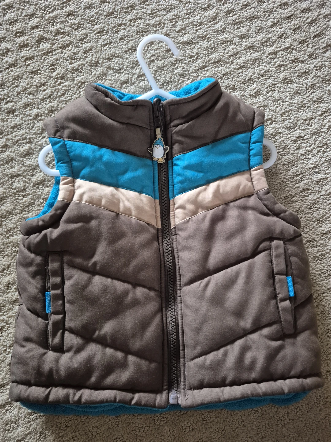 Blue and Brown Puffer Vest with Penguin Zipper Pull