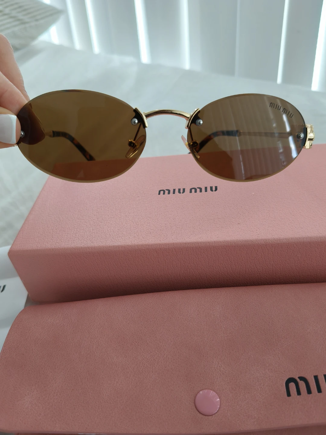 Miu Miu Oval Sunglasses