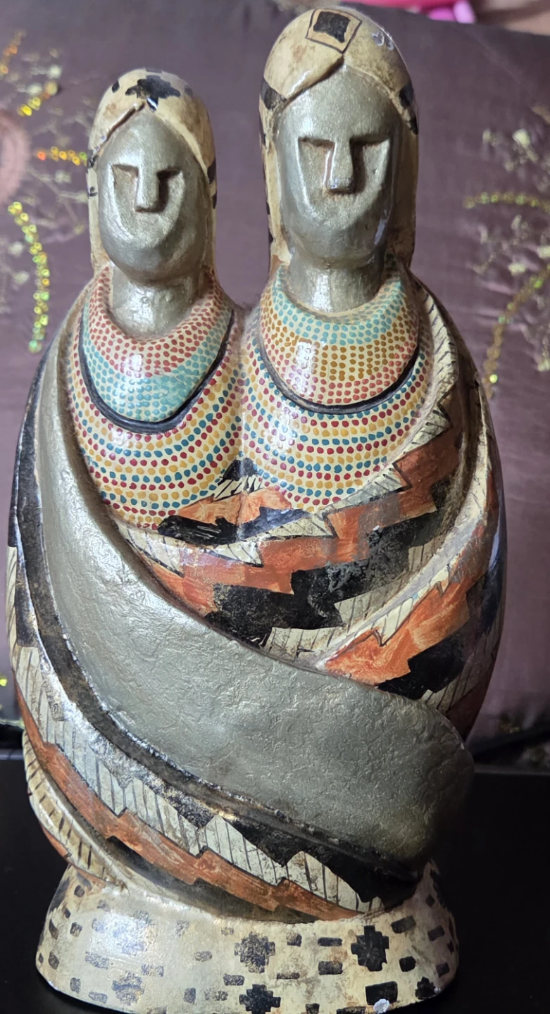 Hand-carved wooden figurine of two figures