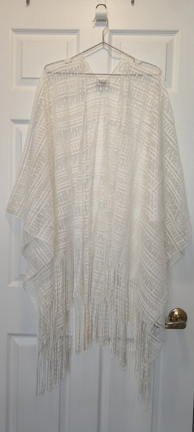 white crochet swimsuit cover-up poncho with a fringe trim