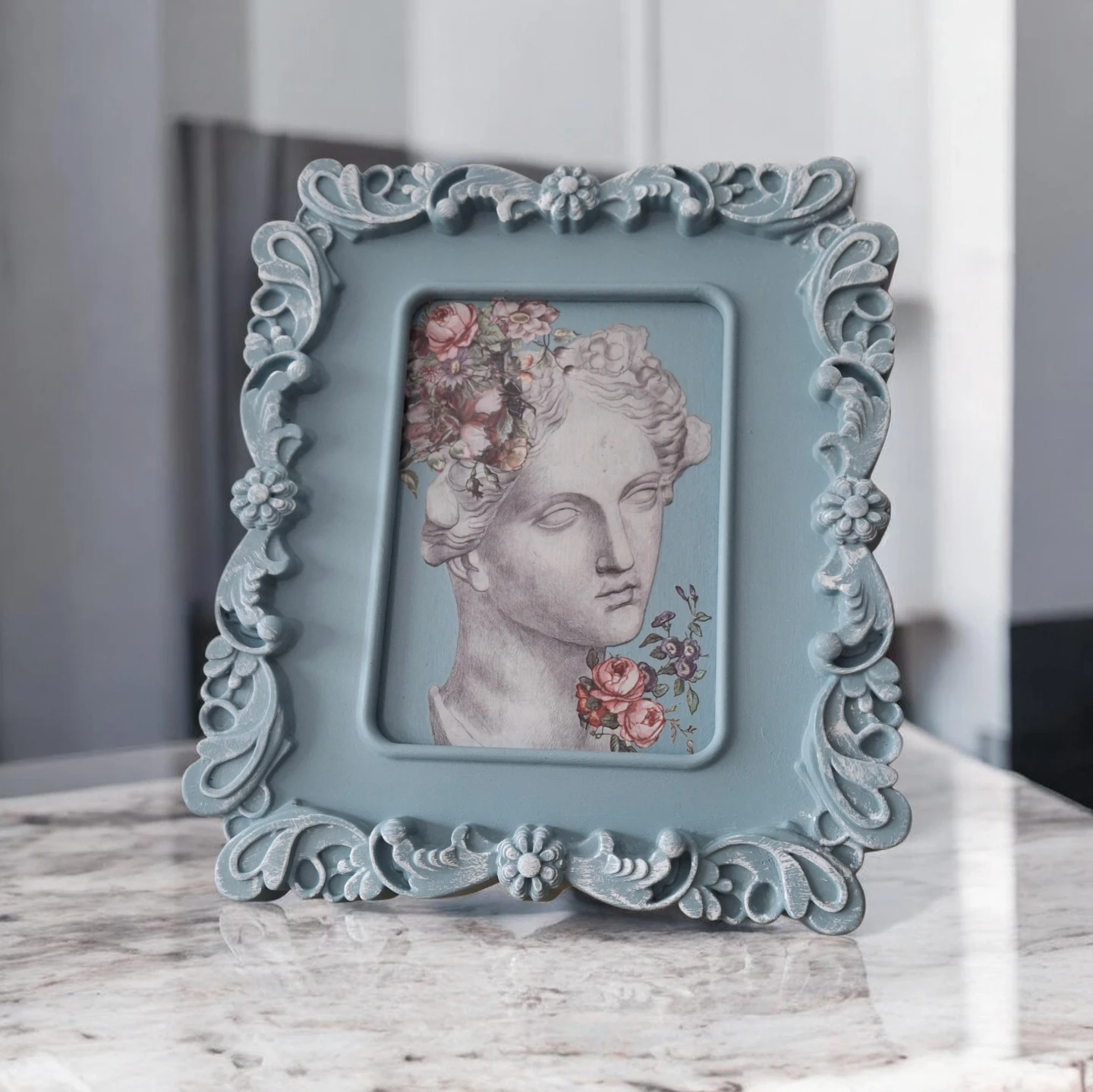 Ornate Blue Picture Frame with Floral Bust Art