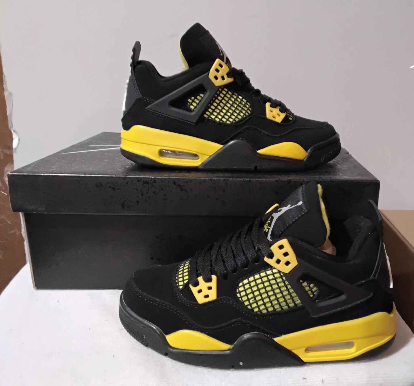 Air Jordan 4 "Thunder" Black and Yellow Sneakers