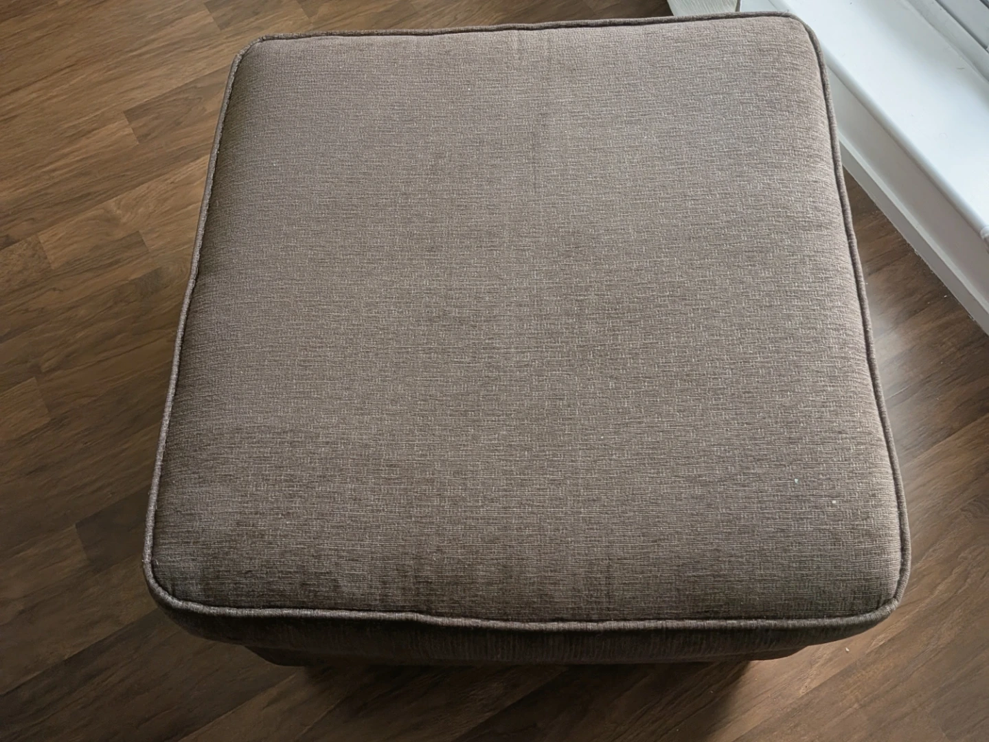 Brown upholstered ottoman