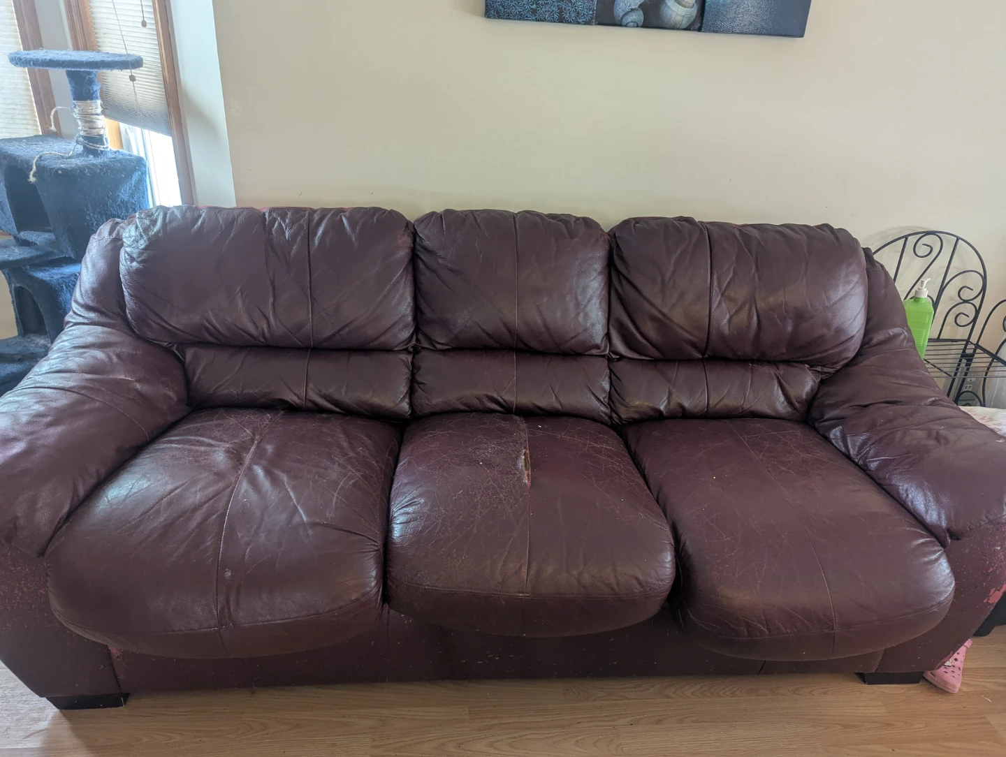 Burgundy hide a bed couch.