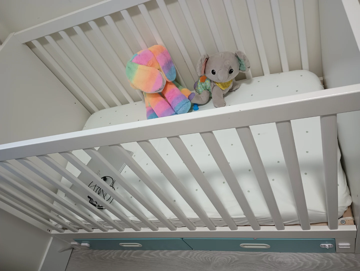 White Wooden Crib with Teal Storage Drawers