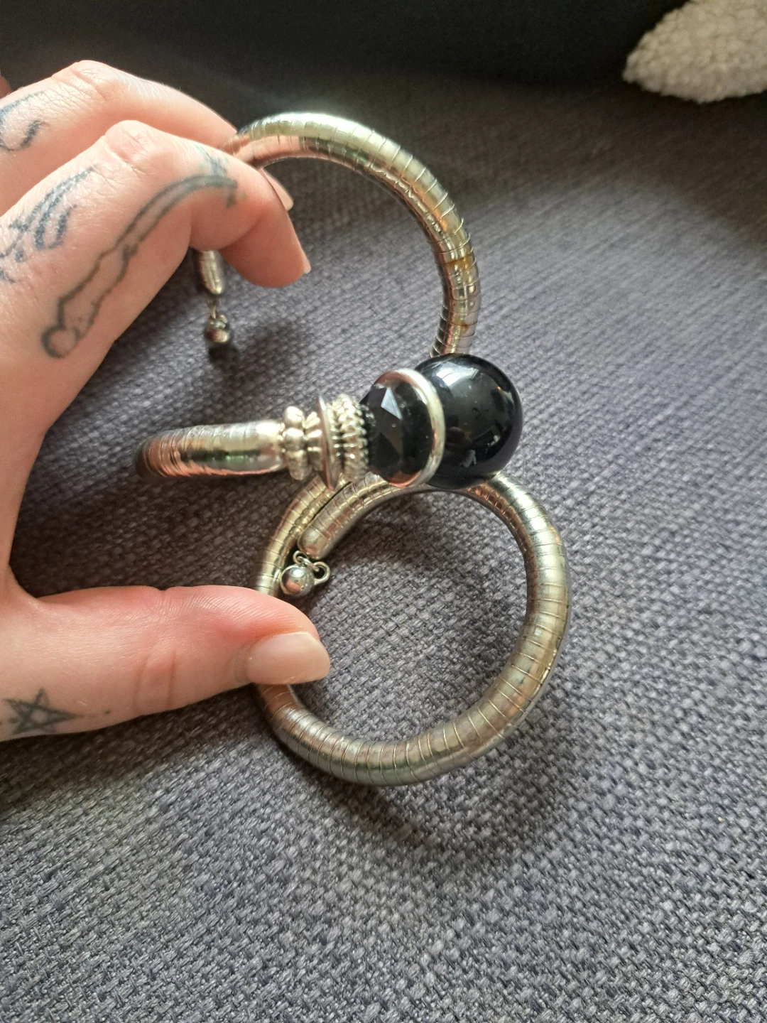 Silver tone bangle bracelet with black beads