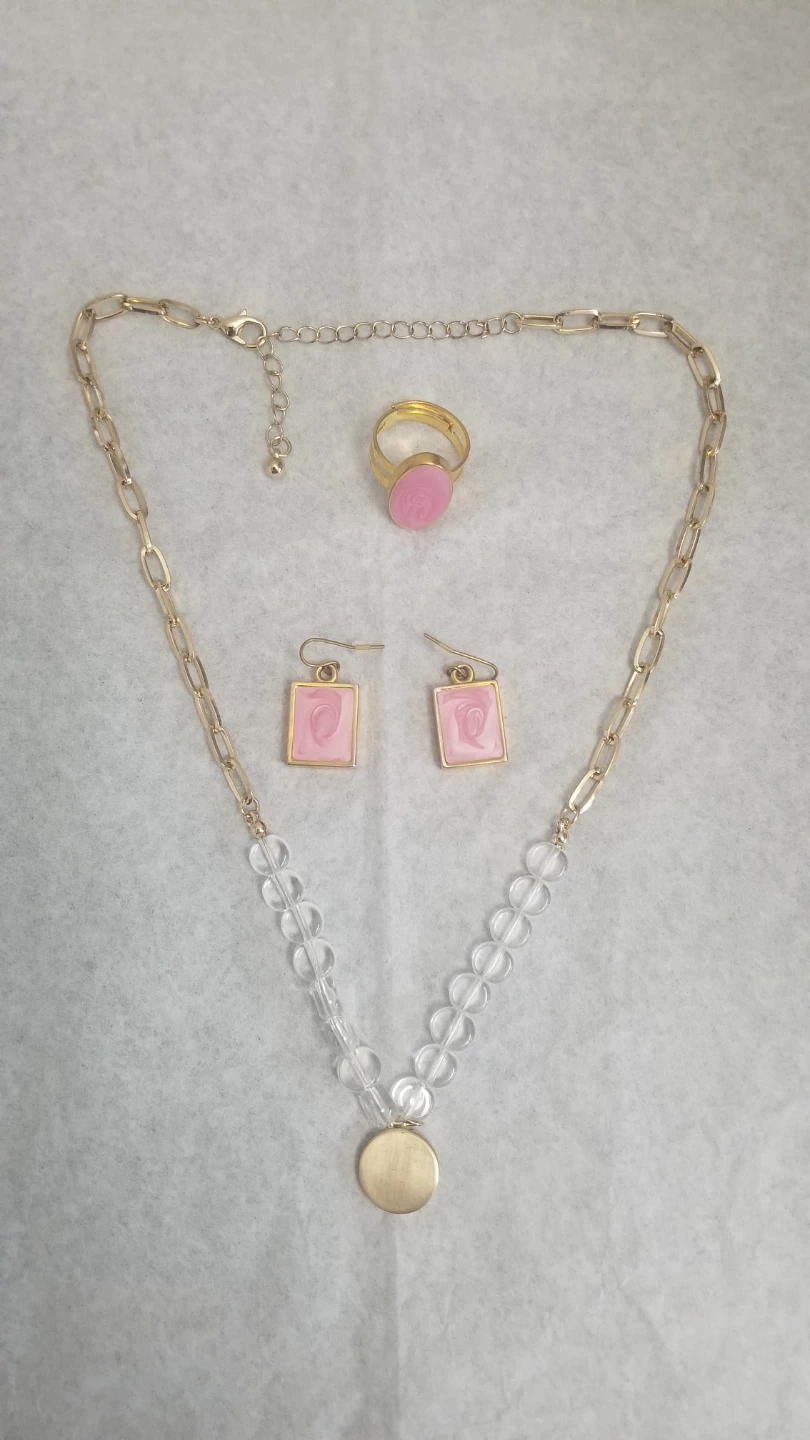Gold tone ring and earrings set with pink swirl design