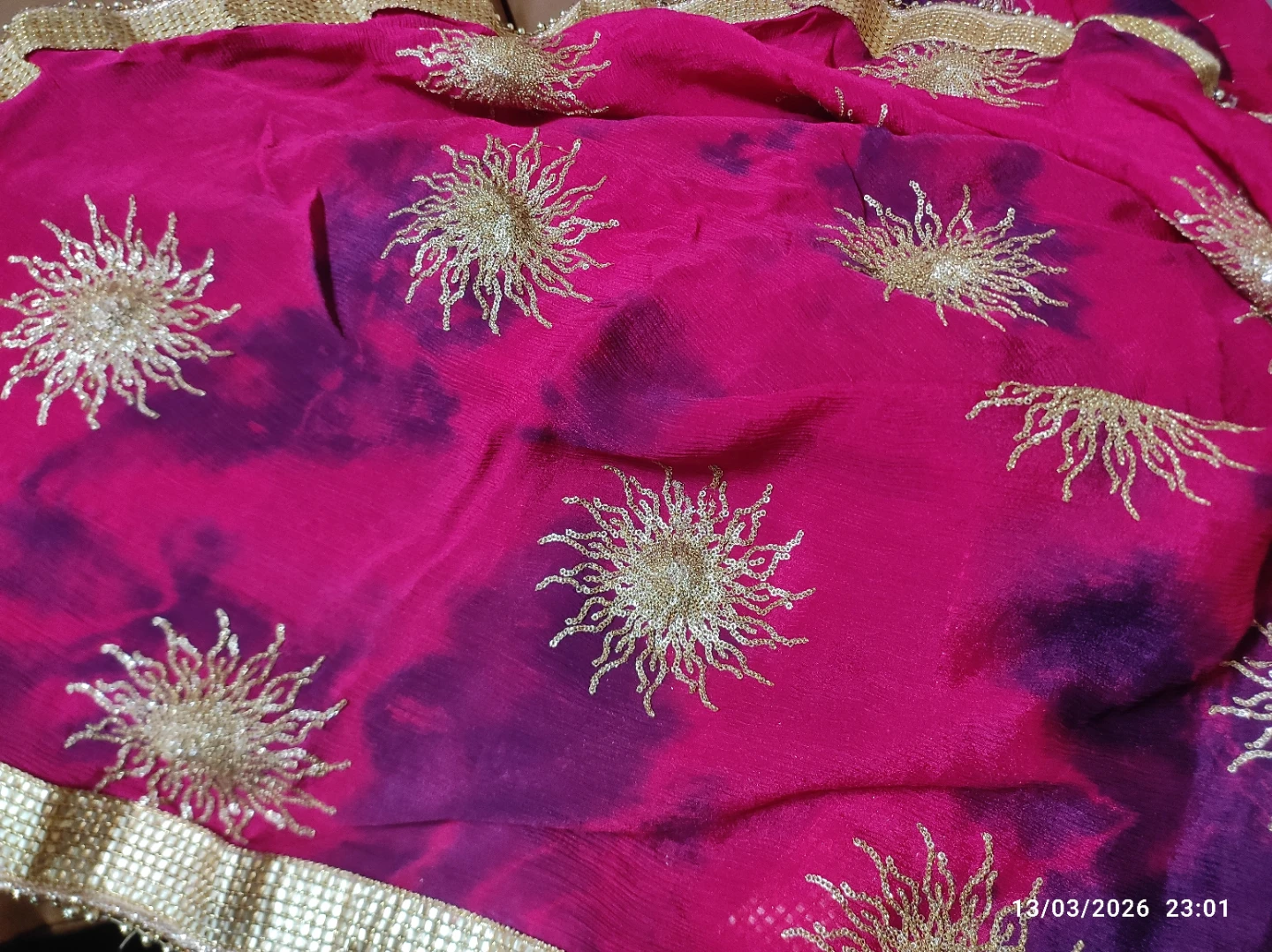 Pink and purple tie-dye fabric with gold embroidered suns
