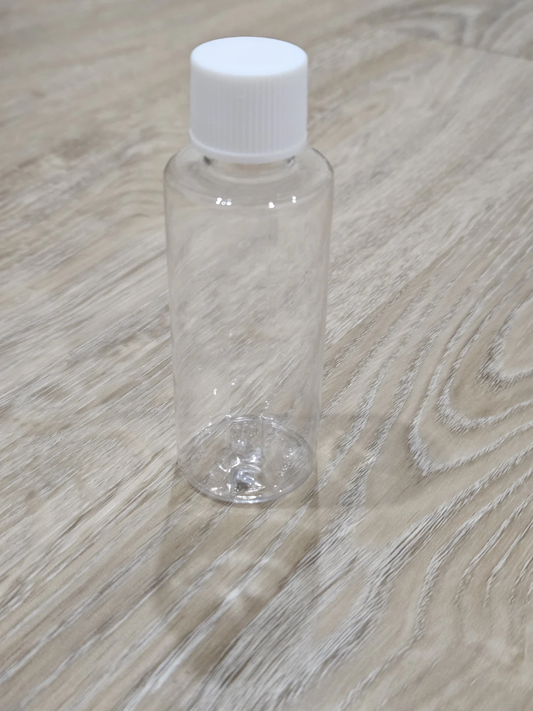 Clear Plastic Travel Bottle with White Cap