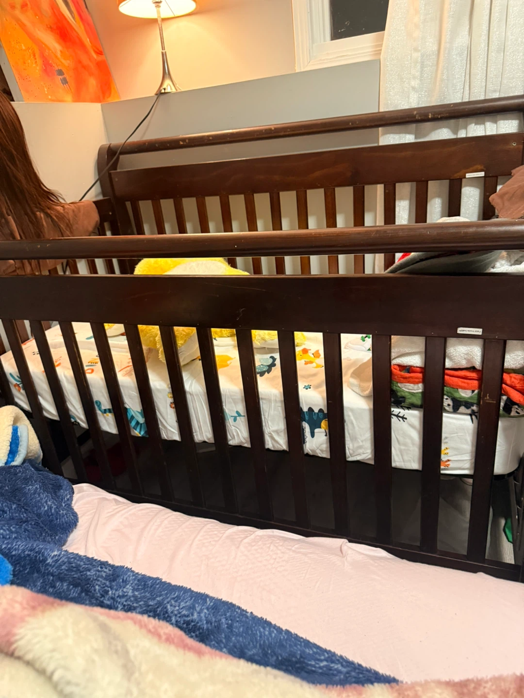 Dark Wood Baby Crib with Dino Print Sheet