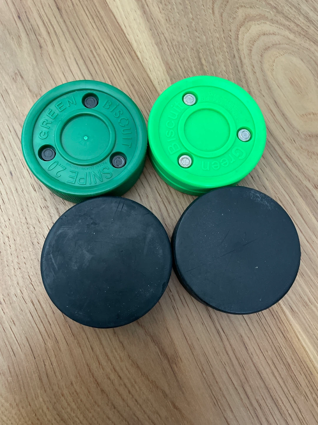 Green Biscuit Hockey Pucks - Set of 2 + 2 regular pucks