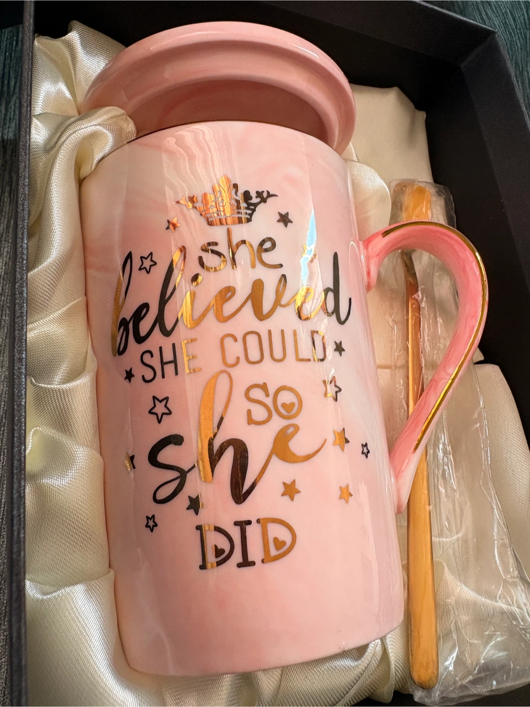 pink mug, lid, and spoon.