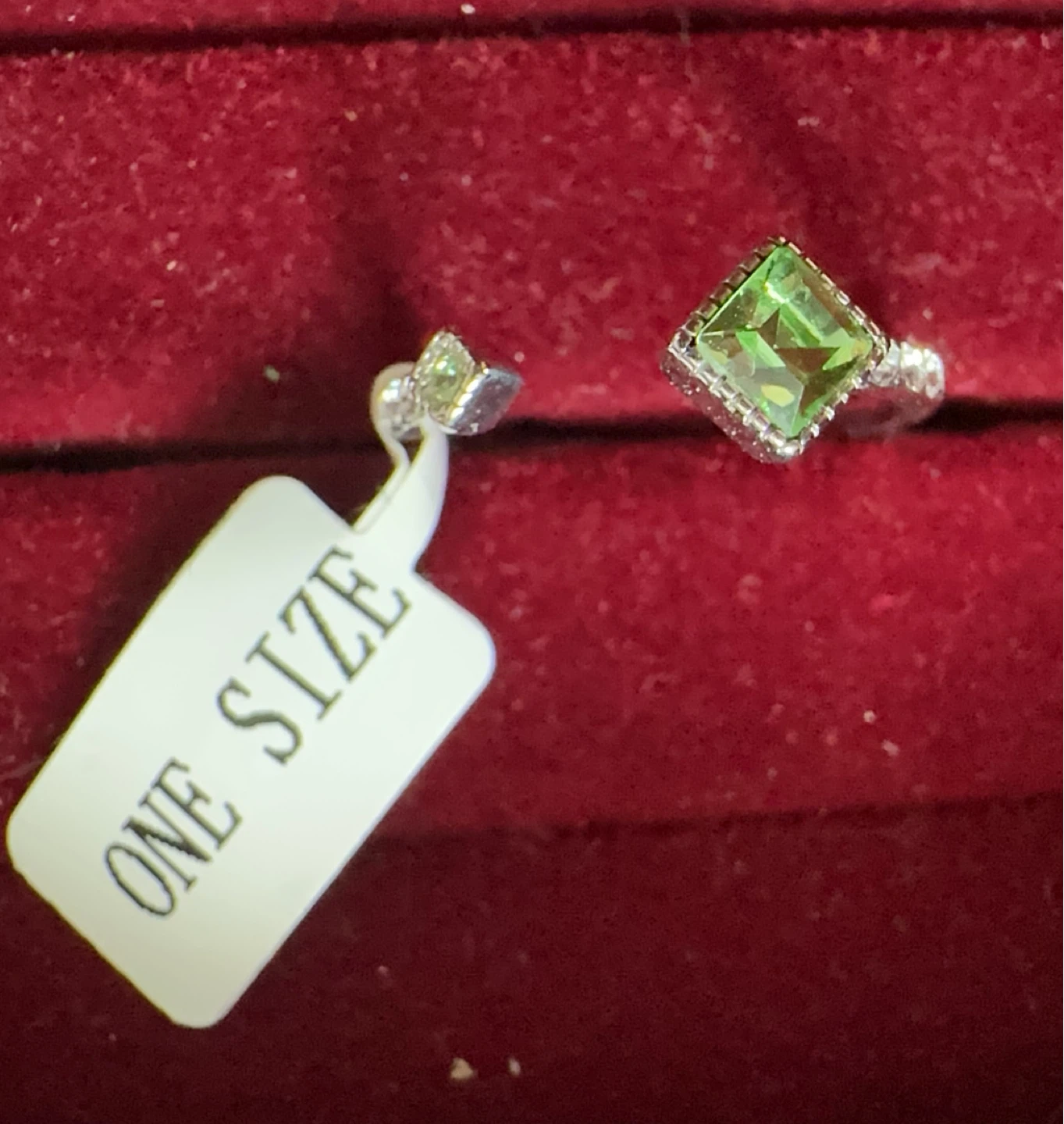 Silver-tone ring with green stone, one size