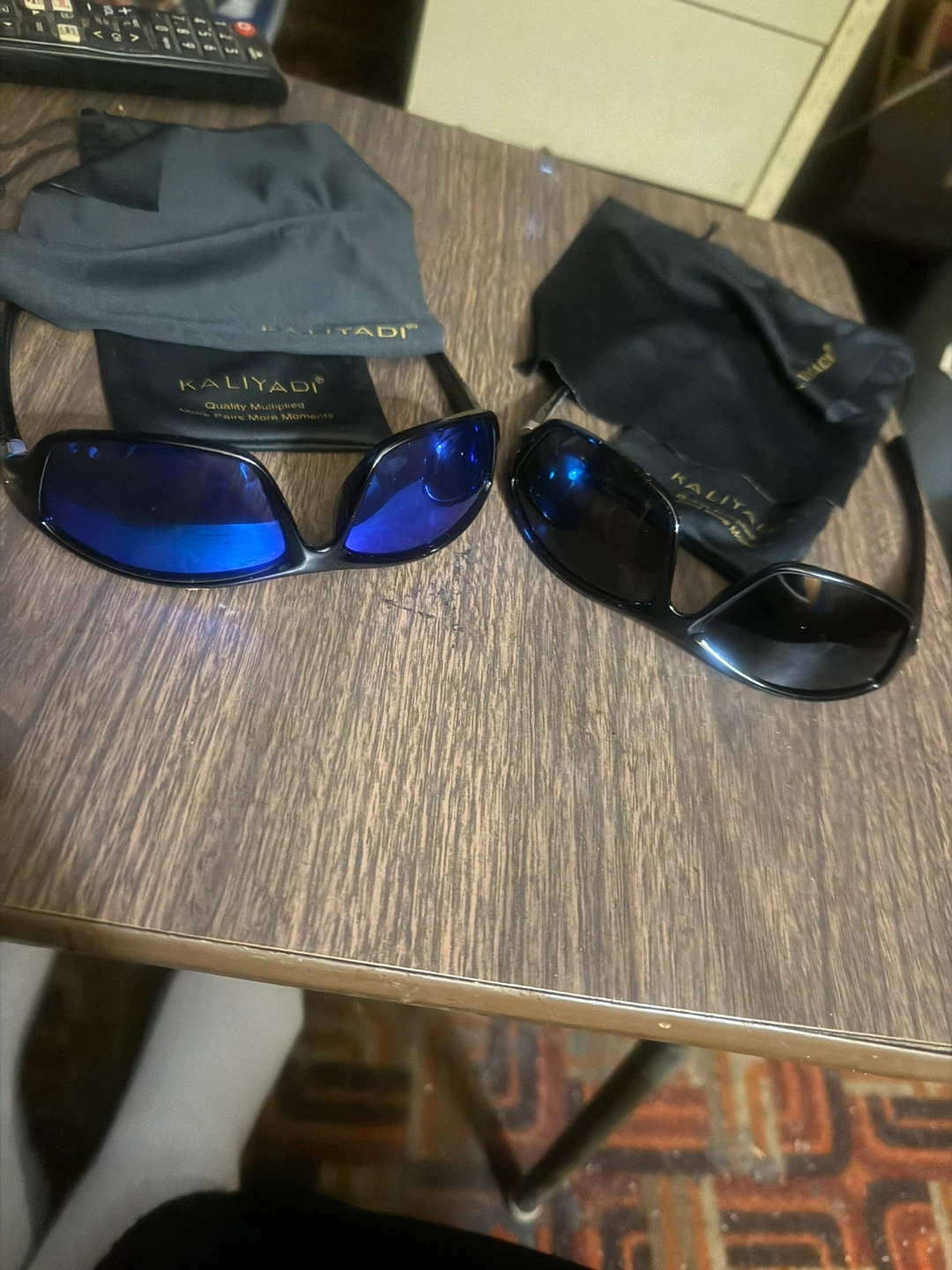 A pair of black, a pair of blue polarized sunglasses!