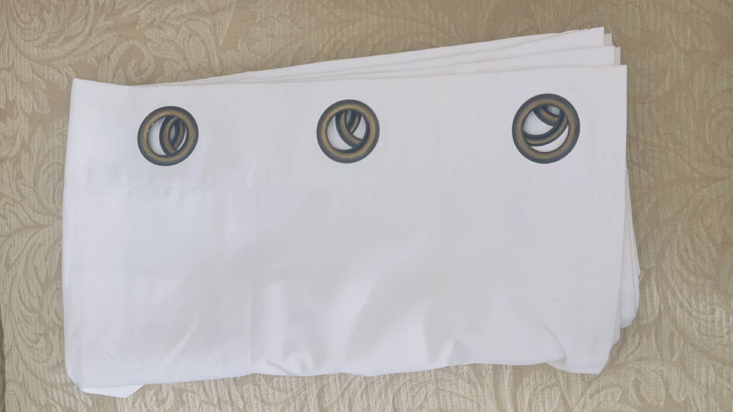 One 7’ White Grommet Curtains