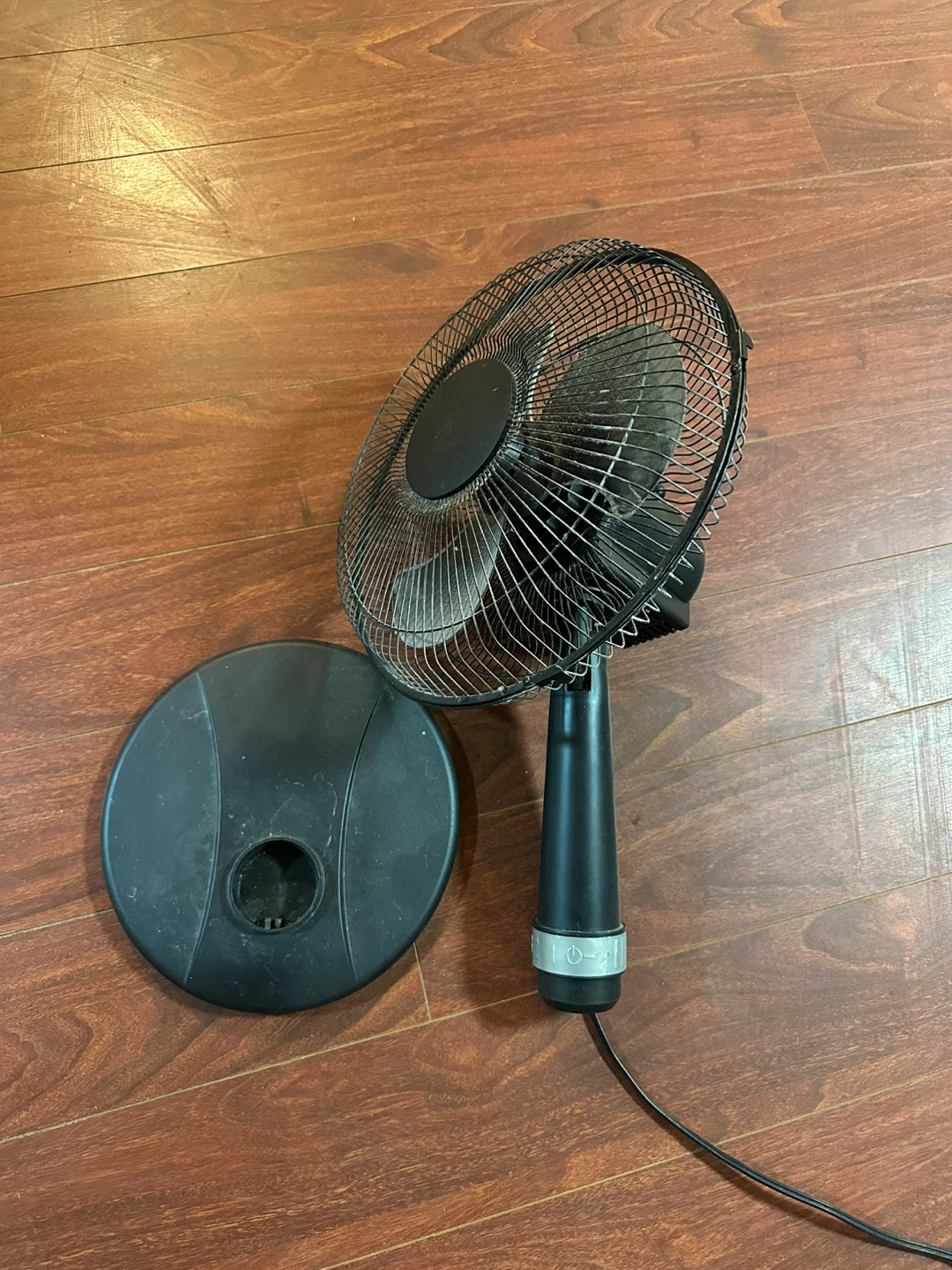 Black oscillating fan with base
