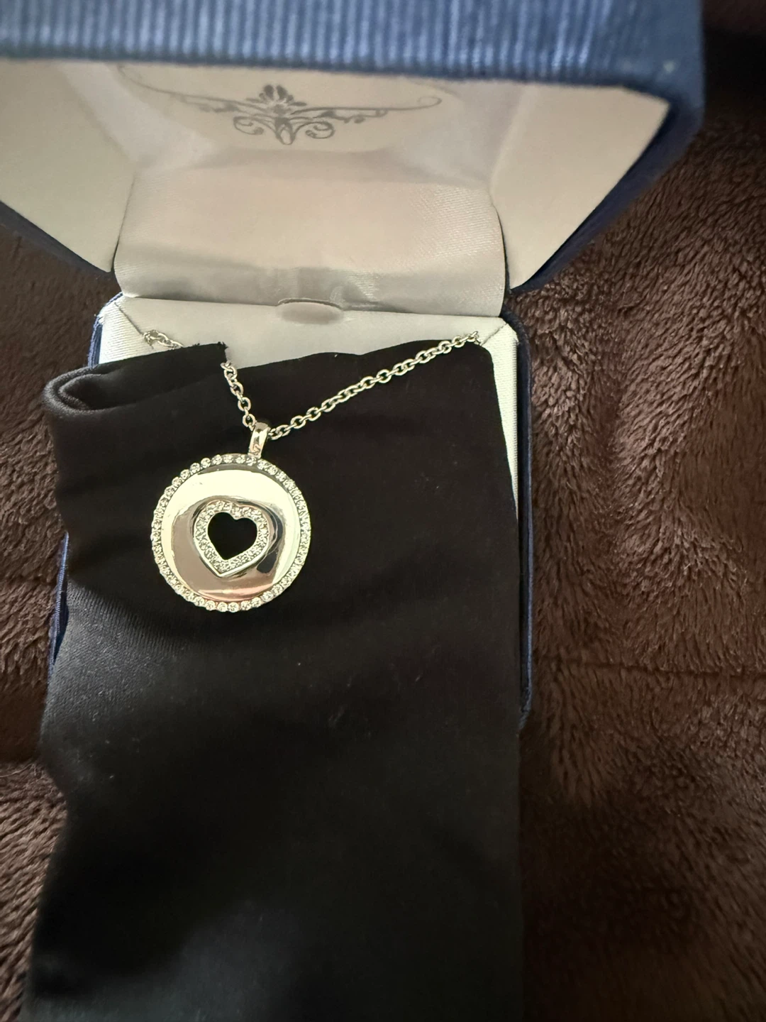 Silver tone necklace with heart pendant and crystal accents
