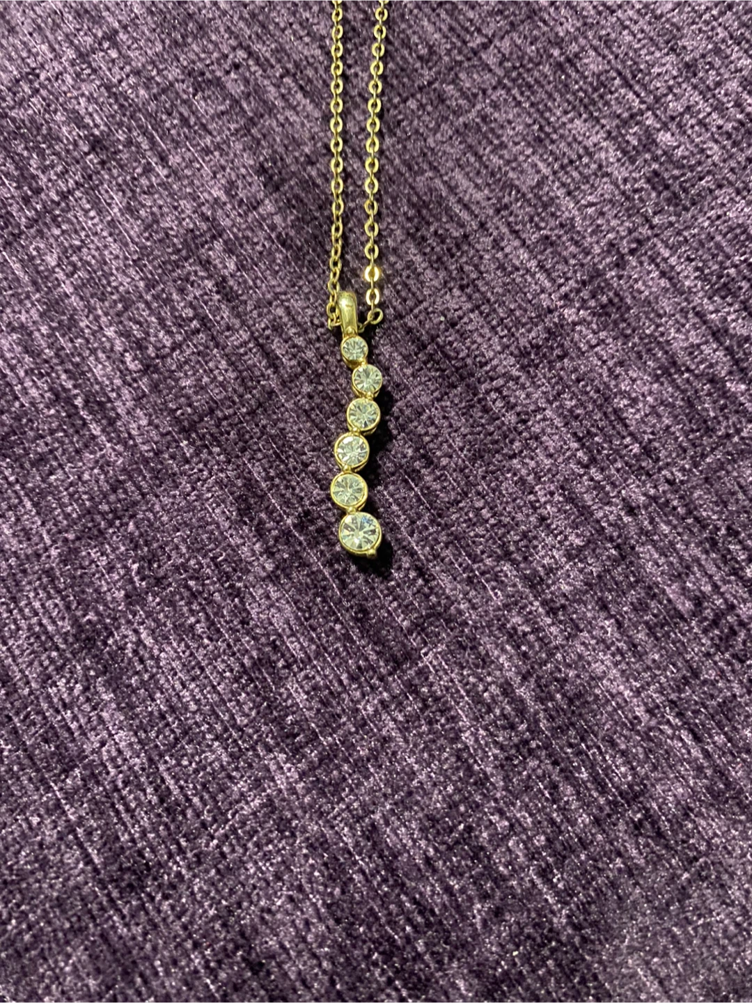 Gold tone necklace with 5 rhinestones