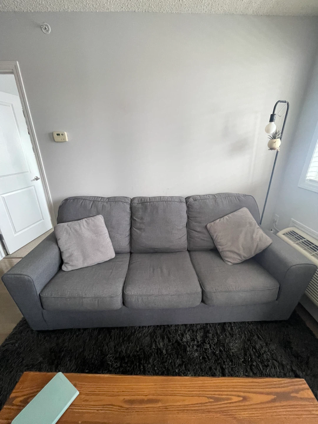 Grey three-seater sofa bed