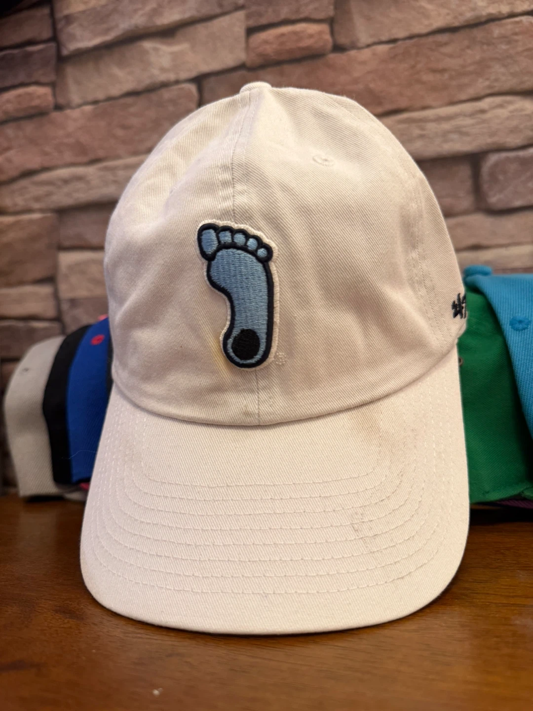 White Baseball Cap with Blue Foot Logo