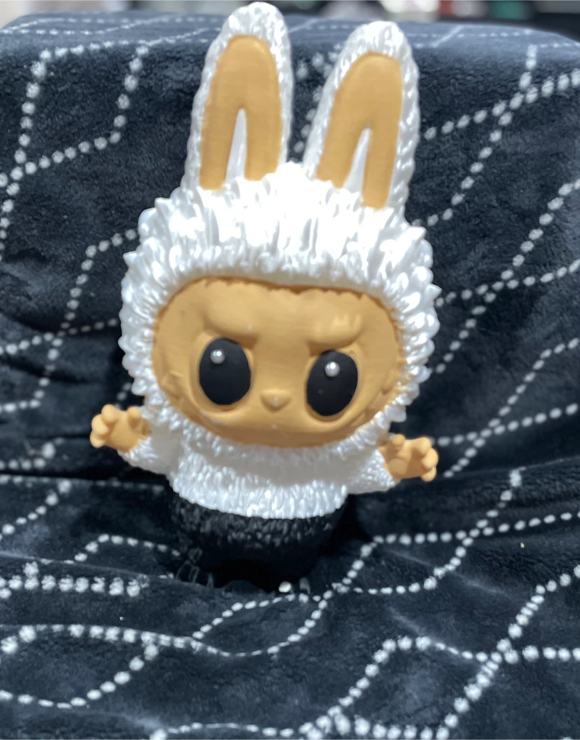White and black laboobuu figurine