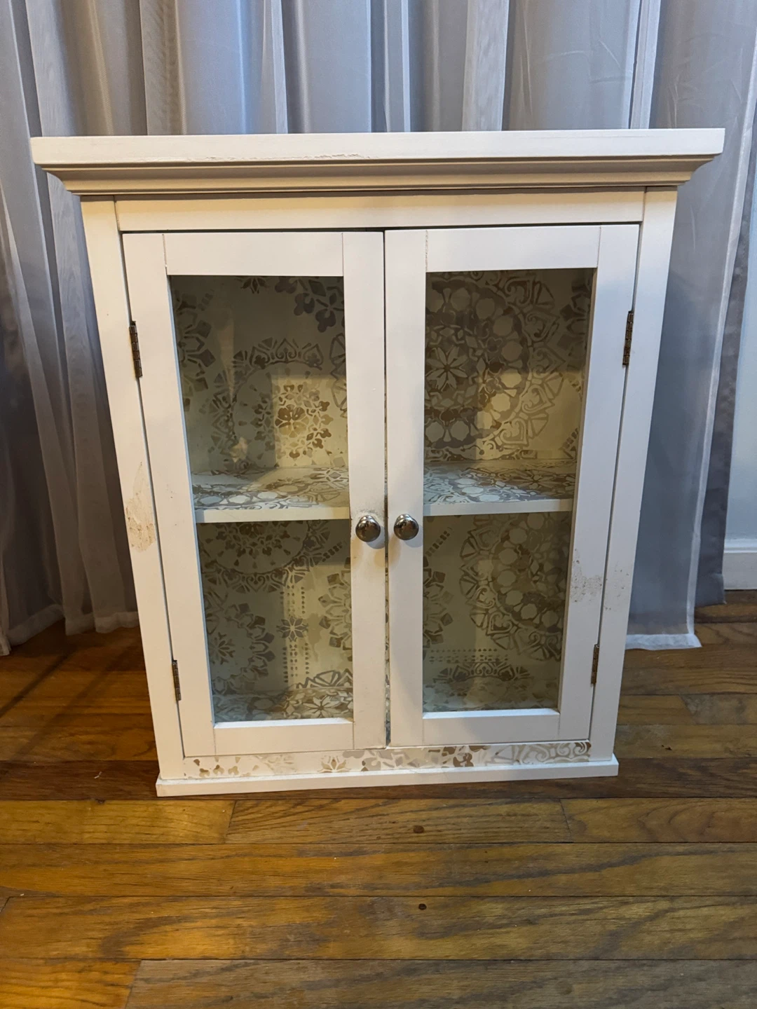 White Two-Door Display Cabinet with Decorative Interior